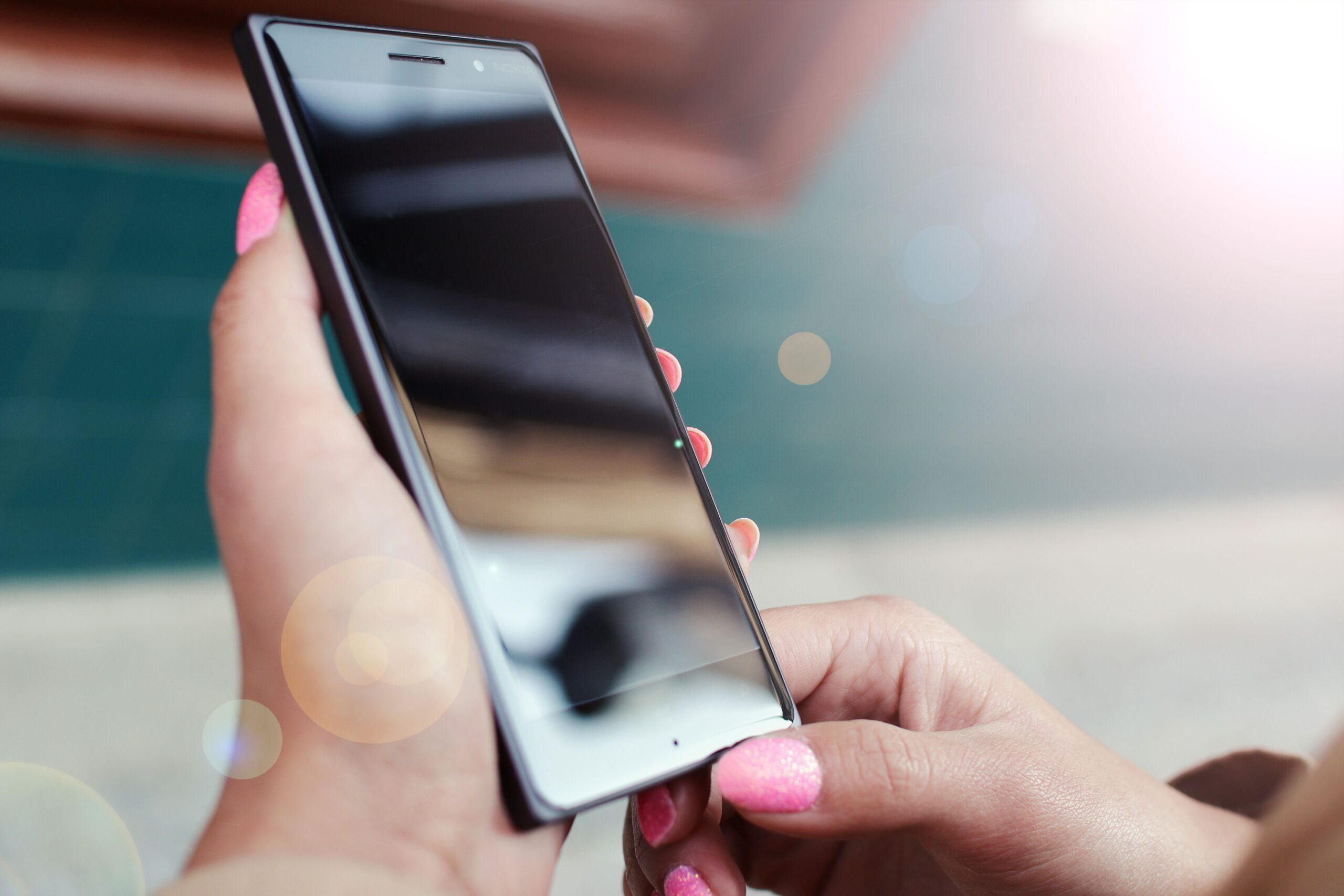 Hands with a phone scaled